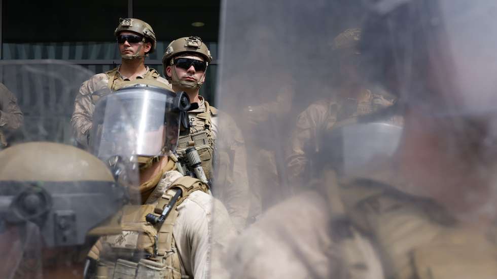 epaselect epa12176502 United States Marines and United States National Guard members stand outside a federal building during a "No Kings Day" protest against President Donald Trump's policies in Los Angeles, California, USA, 14 June 2025. 'No Kings' protests were held all over the country to protest Trump administration policies.  EPA/CAROLINE BREHMAN