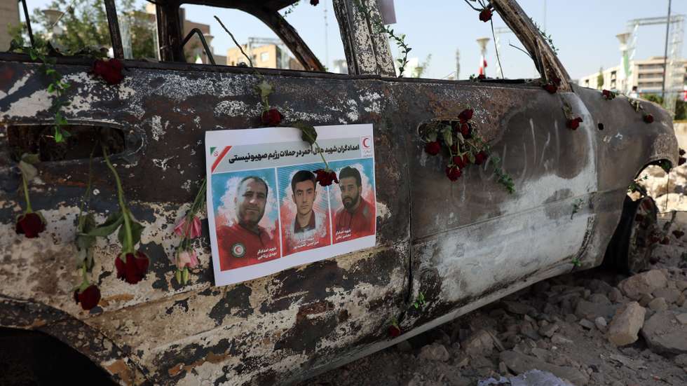 epa12193109 Pictures of three IRCS members posted on an ambulance of the Iranian Red Crescent Society (IRCS) that was destroyed in an Israeli strike, in Tehran, Iran, 23 June 2025. The US Department of Defense announced on 22 June that the United States conducted strikes against three nuclear facilities in Iran; these strikes follow Israel's ongoing campaign across Iran since 13 June, which has targeted nuclear, military, and energy facilities, and prompted Iran to launch retaliatory waves of missiles and drones toward Israel.  EPA/ABEDIN TAHERKENAREH