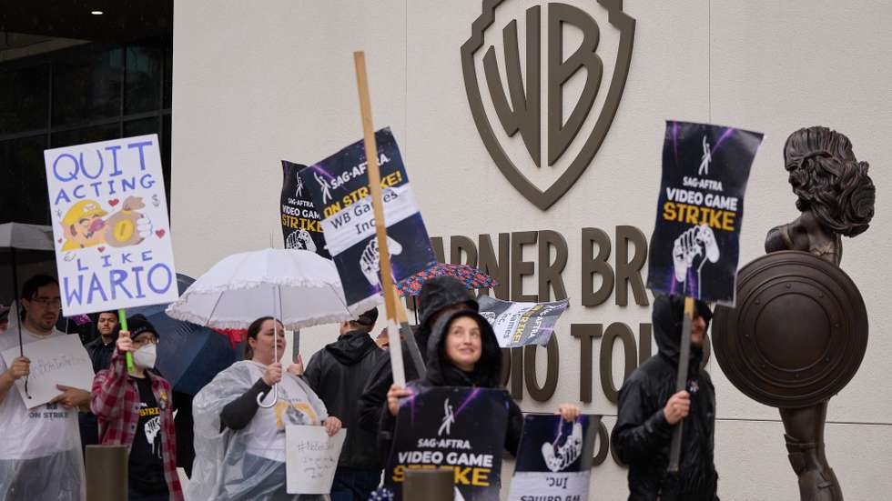 epaselect epa11943189 Members of SAG-AFTRA (Screen Actors Guild-American Federation of Television and Radio Artists) display placards while participating in a picket outside WB Games Inc. in Burbank, California, USA, 05 March 2025. Members of SAG-AFTRA have been on strike since July 2024 against video game companies that signed the Interactive Media Agreement over AI protections for voice and motion performers.  EPA/ALLISON DINNER