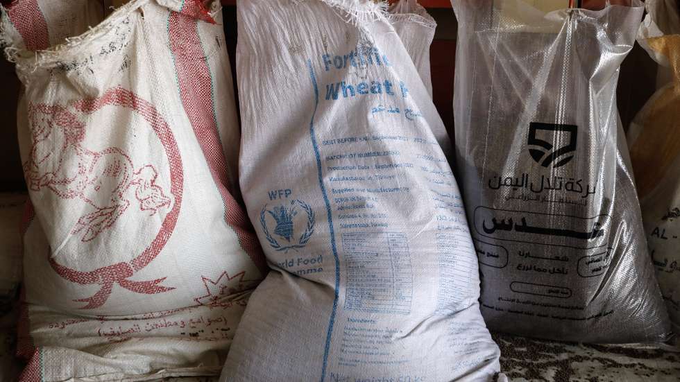 epa10823714 A sack (C) of the World Food Program (WFP) is being filled with grain at a warehouse of locally harvested-grain crops, amid food insecurity, in Sana'a, Yemen, 27 August 2023. The World Food Programme (WFP) has warned that approximately 4.4 million people in Yemen relying on WFP's food assistance could see further reductions starting from the end of September onward, three months after the UN's food agency cut food aid for 13 million Yemenis by over 50 percent due to funding shortages. Yemen remains one of the worst humanitarian crises in the world, with more than two-thirds of its 30-million population requiring some form of humanitarian assistance and protection after over eight years of war, according to estimates by the United Nations.  EPA/YAHYA ARHAB