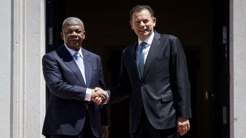 Portugal's Prime Minister Luis Montenegro (R) greets Angola's President Joao Lourenco (L) during the welcome ceremony at Sao Bento Palace in Lisbon, Portugal, 25 July 2025. FILIPE AMORIM/LUSA