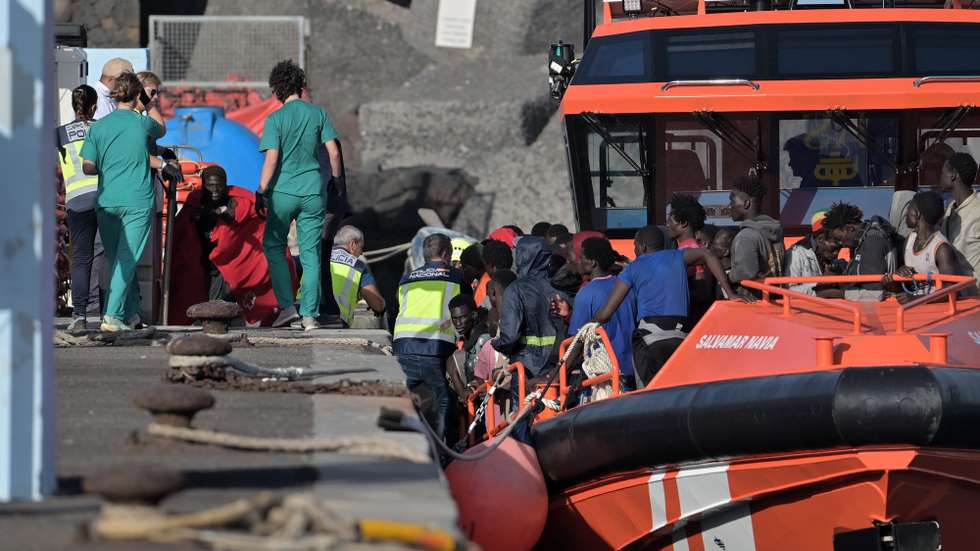 epa12379666 Immigrants are assisted upon arrival at La Restinga harbor on El Hierro island, Canary Islands, Spain, 15 September 2025. Navia and Diphda sea rescue ships rescued 235 people from a cayuco (small wooden boat) in waters near El Hierro on the same day.  EPA/Gelmert Finol