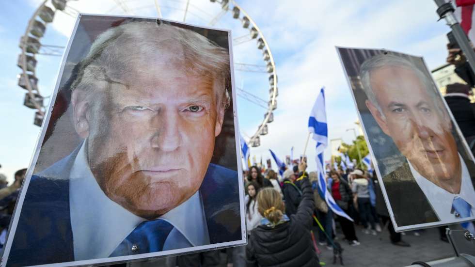 epa12448740 Portraits of US President Trump (L) and Israeli Prime Minister Netanyahu are on display as people take part in a national march organized by the Alliance for Peace in the Middle East, in Brussels, Belgium, 12 October 2025. The rally commemorated the victims of the 07 October 2023 Hamas attacks in Israel and condemned antisemitism.  EPA/FREDERIC SIERAKOWSKI