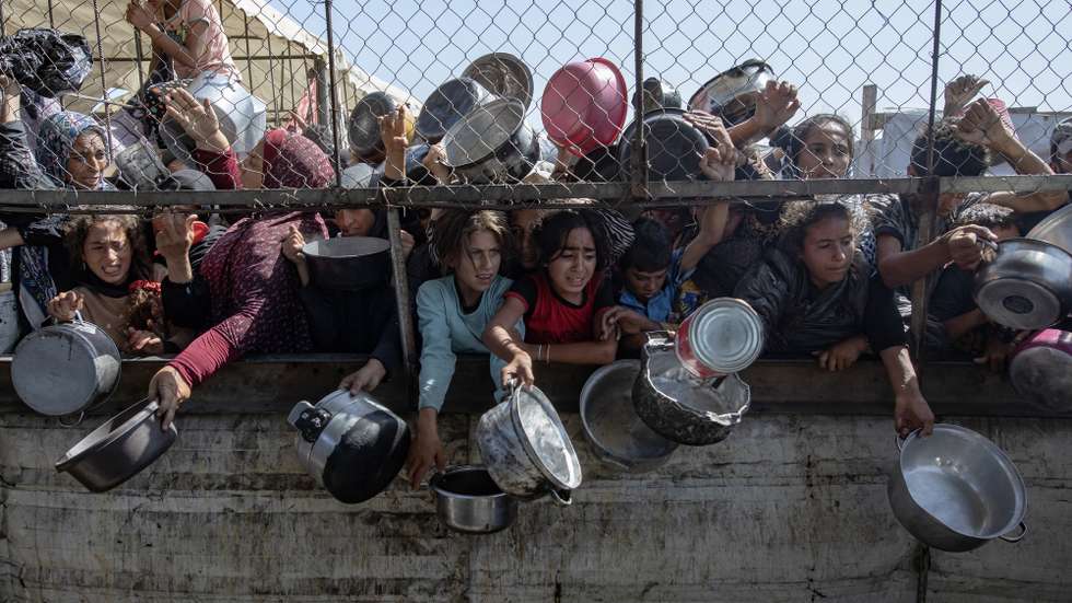 epa12434321 (FILE) - Internally displaced Palestinians gather outside a charity kitchen to receive limited rations amid a shortage of food, in Khan Younis, southern Gaza Strip, 30 May 2025  (reissued 06 October 2025). 07 October 2025 marks two years since the Palestinian militant group Hamas launched a surprise attack on Israel, taking dozens of hostages and killing nearly 1,200 people. In response, Israel began its war on Gaza, which has killed more than 66,000 people, displaced millions and destroyed the Palestinians enclave.  EPA/HAITHAM IMAD