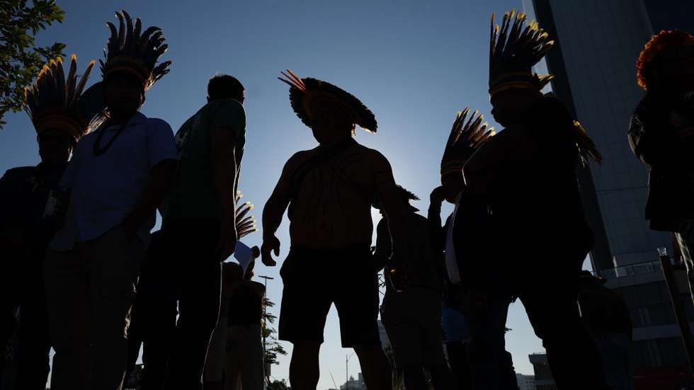 epa12181032 Indigenous people participate in a protest in Rio de Janeiro, Brazil, 17 June 2025. Brazil's National Petroleum Agency (ANP) is promoting an auction in which it is offering the concession to explore and exploit 172 areas in eleven sedimentary basins in the country, including 47 blocks in a controversial marine area near the mouth of the Amazon.  EPA/Antonio Lacerda