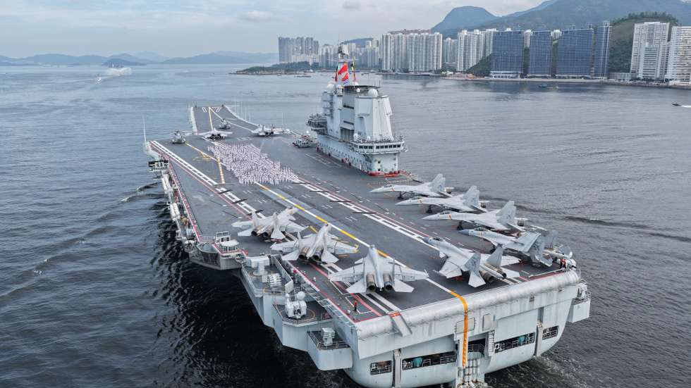 epa12211828 Officers and soldiers spelling out Chinese characters 'secure country, sweet home' on aircraft carrier Shandong's flight deck in Hong Kong waters, China, 03 July 2025. A fleet of the Chinese People's Liberation Army (PLA) Navy led by the aircraft carrier Shandong arrived in the Hong Kong Special Administrative Region (HKSAR) on 03 July morning, kicking off a five-day visit. The aircraft carrier and the Yan'an missile destroyer were anchored near the west end of the Victoria Harbor, while the Zhanjiang missile destroyer and the Yuncheng missile frigate docked at the PLA Hong Kong Garrison's naval base in Stonecutters Island. This is the Shandong's first visit to Hong Kong. From Friday to Sunday, the Shandong, the Zhanjiang and the Yuncheng will host open tours, lectures, drill demonstrations and other exchange activities.  EPA/XINHUA / LIU FANG CHINA OUT / UK AND IRELAND OUT  /       MANDATORY CREDIT EDITORIAL USE ONLY