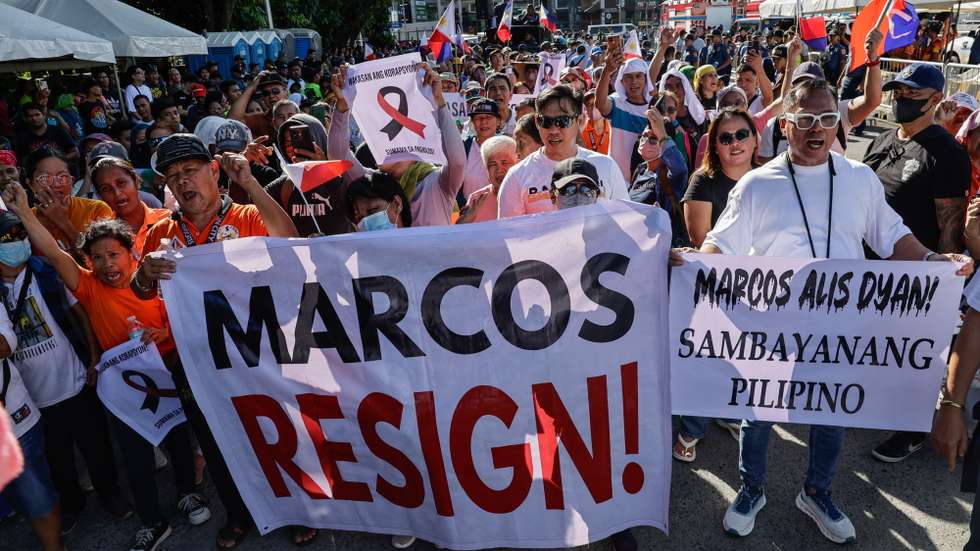 epa12528812 Protesters hold signs calling for the resignation of Philippine President Ferdinand 'Bongbong' Marcos Jr., during an anti-corruption rally in Quezon City, Metro Manila, Philippines, 16 November 2025. Ongoing investigations into government infrastructure programs, including flood control projects, have led various cause-oriented groups to hold mass demonstrations against corruption allegedly committed by low-level officials up to the highest ranked leaders in the country.  EPA/ROLEX DELA PENA