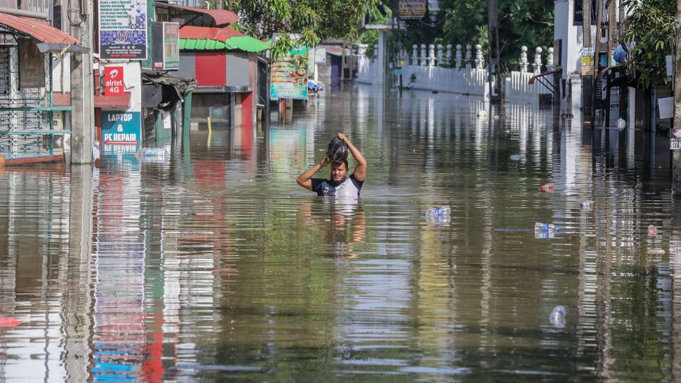 epa12559521 A person wades through a flooded road after heavy rainfall in a suburb of Colombo, Sri Lanka, 30 November 2025. Many parts of the island have been inundated due to heavy rains. According to the Sri Lanka Disaster Management Center, more than 160 people have been killed and about 200 are missing around the country.  EPA/CHAMILA KARUNARATHNE