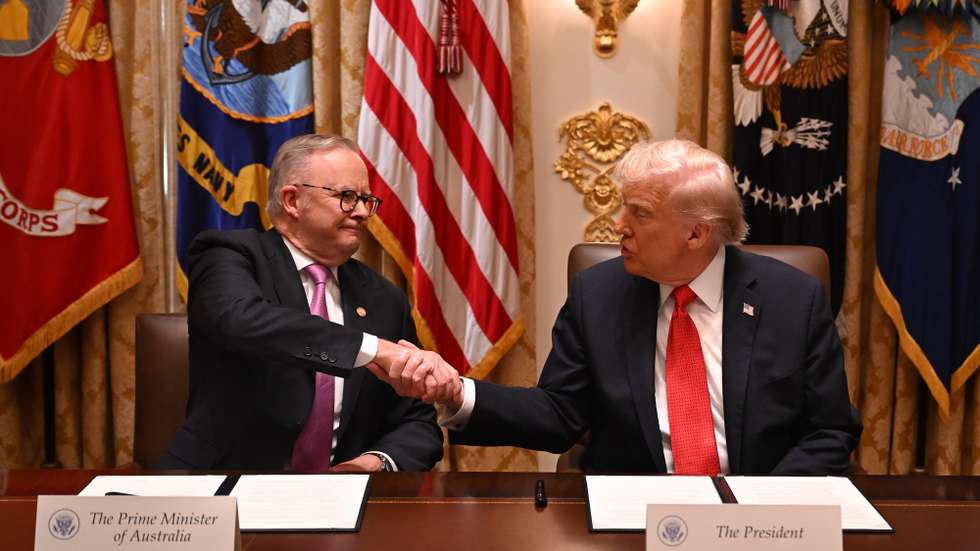 epa12468549 Australian Prime Minister Anthony Albanese (L) and US President Donald Trump (R) sign a US- Australia Framwork for Securing of Supply in the Mining and Processing of Critical Minerals and Rare Earths during a meeting in the Cabinet Room at the White House in Washington, D.C., USA, 20 October 2025.  EPA/LUKAS COCH AUSTRALIA AND NEW ZEALAND OUT