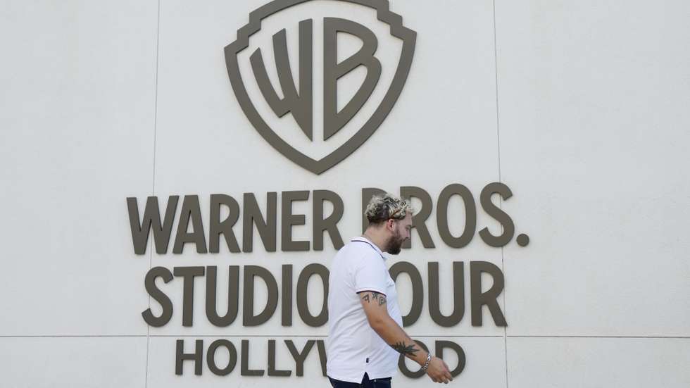 epa12471315 A person walks by the Warners Bros. studio tour location at the Warner Bros. Studio Lot in Burbank, California, USA, 21 October 2025. Warner Bros. Discovery revealed in a press release on 21 October that it is putting the company up for sale.  EPA/CAROLINE BREHMAN