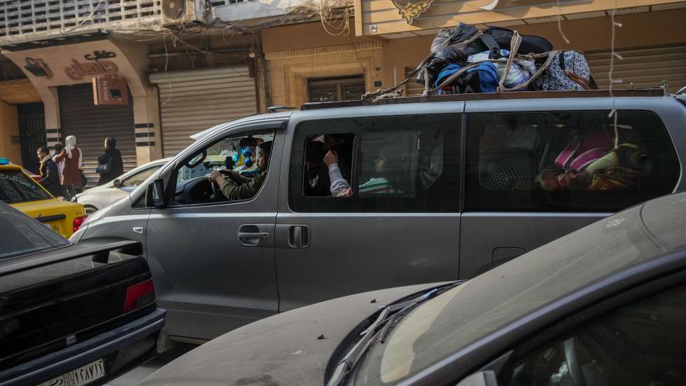 epa12634100 People ride a van as they flee Aleppo, Syria, 07 January 2026. Thousands of civilians evacuate the Sheikh Maqsoud and Ashrafieh neighborhoods after the Syrian army declared the districts a military zone. The move follows deadly clashes between the Syrian army and Kurdish-led Syrian Democratic Forces (SDF) that erupted on 06 January.  EPA/AHMAD FALLAHA