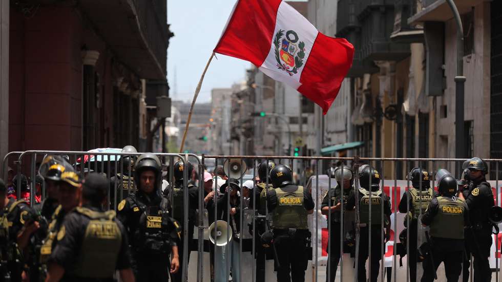 epa12750957 A person holds a Peruvian flag during a demonstration against interim president Jose Jeri in front of the Peruvian Congress in Lima, Peru, 17 February 2026. The Peruvian Congress began a special session to discuss seven motions of censure filed against Jeri, which could lead to the eighth presidential change in the Andean country in nearly a decade of political instability.  EPA/Paolo Aguilar