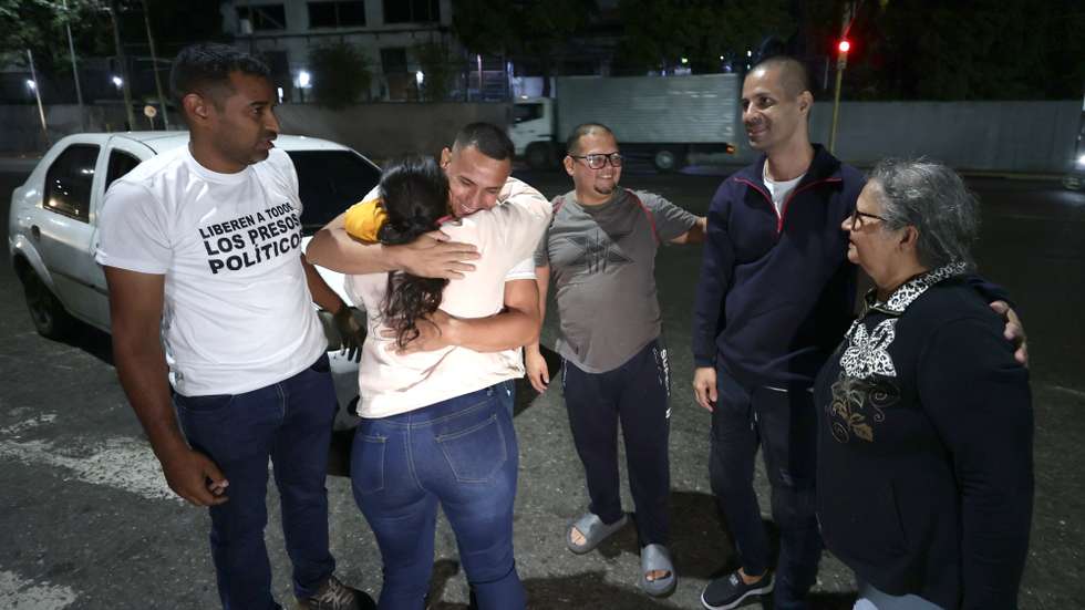 epa12770619 Lewis Jose Mendoza (C), Pedro Andrade (2-L), and Hommel Torres (2-L) greet their family and friends after being released from prison, upon their release from the Bolivarian National Police headquarters in La Yaguara, Caracas, Venezuela, 22 February 2026.  EPA/Ronald Pena R