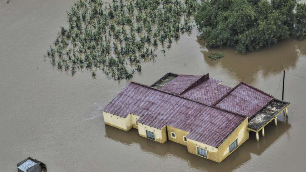 epa12664694 An aerial view shows the flooded 03 February neighbourhood between the Maputo and Gaza regions, Maputo, Mozambique, 20 January 2026. Rescue efforts continue for hundreds of families cut off by flooding, with some taking refuge on rooftops, car roofs, or in treetops in southern Mozambique after days of near-continuous rain that has also forced dams, including some in neighbouring countries, to increase water releases.  EPA/LUISA NHANTUMBO