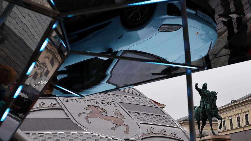 epa12367185 A Porsche Macan 4 is reflected at the Porsche pavilion with the Statue of Maximilian I seen in the background at the IAA Open Space in the city center at the International Motor Show Germany IAA Mobility 2025 in Munich, Germany, 10 September 2025. The IAA Mobility 2025 takes place in Munich from 09 to 14 September 2025, featuring numerous world premieres and a special focus on electric mobility and digitization.  EPA/ANNA SZILAGYI