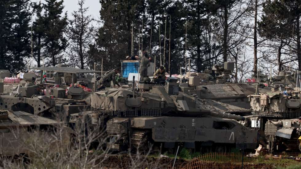 epa12825230 Israeli soldiers with their tanks gather at an undisclosed position along the Israel-Lebanon border in northern Israel, 16 March 2026. The Israeli military stated it is conducting strikes across Lebanon targeting Hezbollah infrastructure and personnel.  EPA/ATEF SAFADI