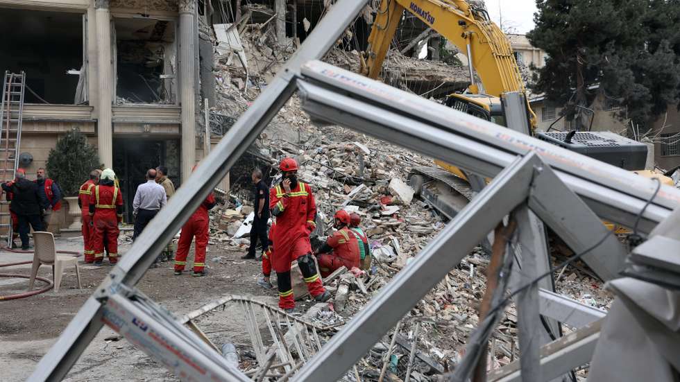epa12843871 Iranian firefighters and officials work at the site of damaged residential buildings in northern Tehran, Iran, 23 March 2026. A joint Israeli and US military operation continues to target multiple locations across Iran since the early hours of 28 February 2026.  EPA/ABEDIN TAHERKENAREH