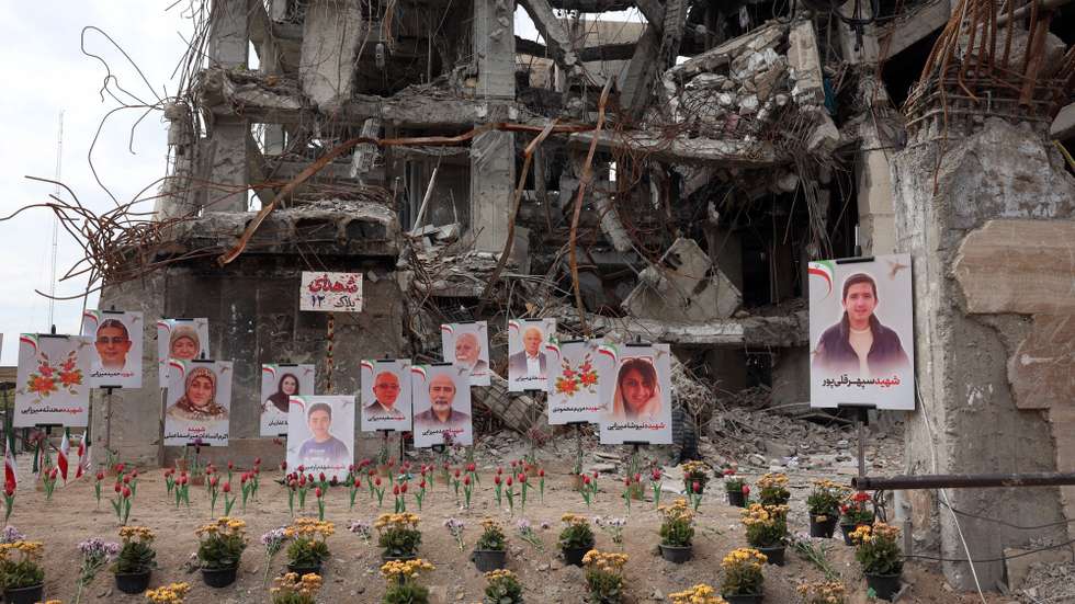 epa12886921 Photographs of people killed in a US-Israeli airstrike on a residential building are displayed in front of the same building in Tehran, Iran, 13 April 2026. Iran and the US have failed to reach an agreement after peace talks held in Islamabad on 11 April.  EPA/ABEDIN TAHERKENAREH