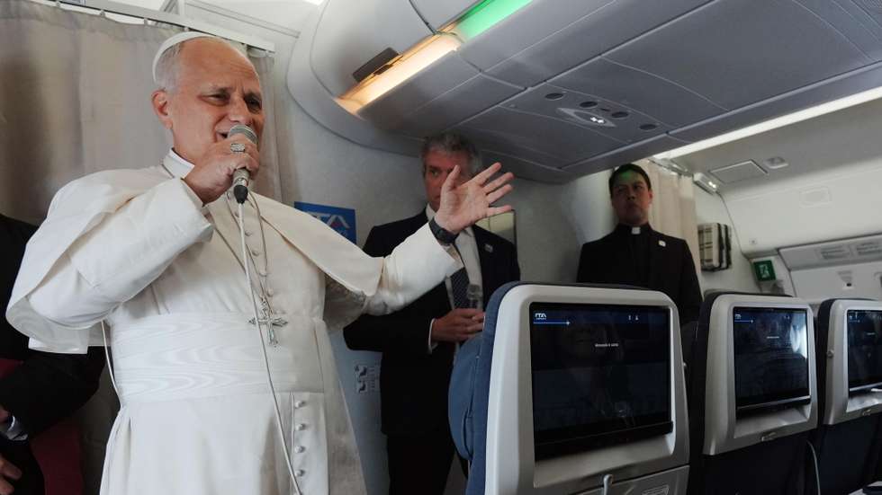 epa12909767 Pope Leo XIV (L) speaks to journalists aboard the papal flight from Malabo, Equatorial Guinea to Rome, Italy, 23 April 2026, at the end of his 11-day apostolic journey to Africa.  EPA/ANDREW MEDICHINI / POOL