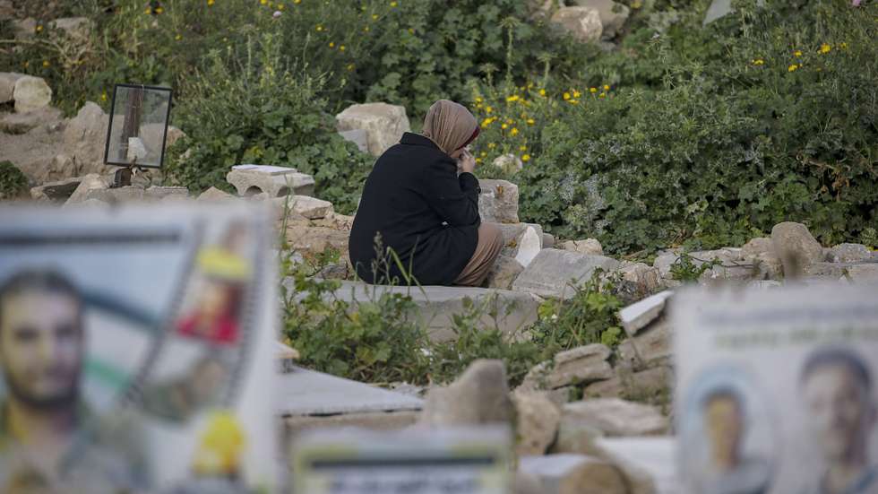 epa12836156 A Palestinian woman sits near the grave of a relative killed during the war at the Old Gaza City cemetery during Eid al-Fitr in Gaza City, 20 March 2026. Eid al-Fitr is a three-day festival celebrated by Muslims worldwide at the end of Ramadan and is one of the two major holidays in the Islamic calendar.  EPA/MOHAMMED SABER
