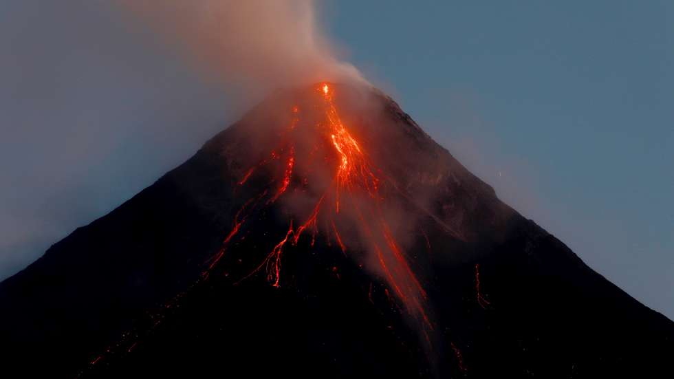 epa10699052 Mayon volcano spews ash and lava in Legazpi City, Albay province, Philippines, 18 June 2023. The Philippine Institute of Volcanology and Seismology (Phivolcs) latest bulletin on 18 June said the Mayon Volcano in Albay continued to exhibit high levels of unrest, spewing lava and triggering rockfall events. Families living within the six kilometer radius danger zone were ordered to evacuate, as a hazardous eruption is possible within days or weeks.  EPA/FRANCIS R. MALASIG