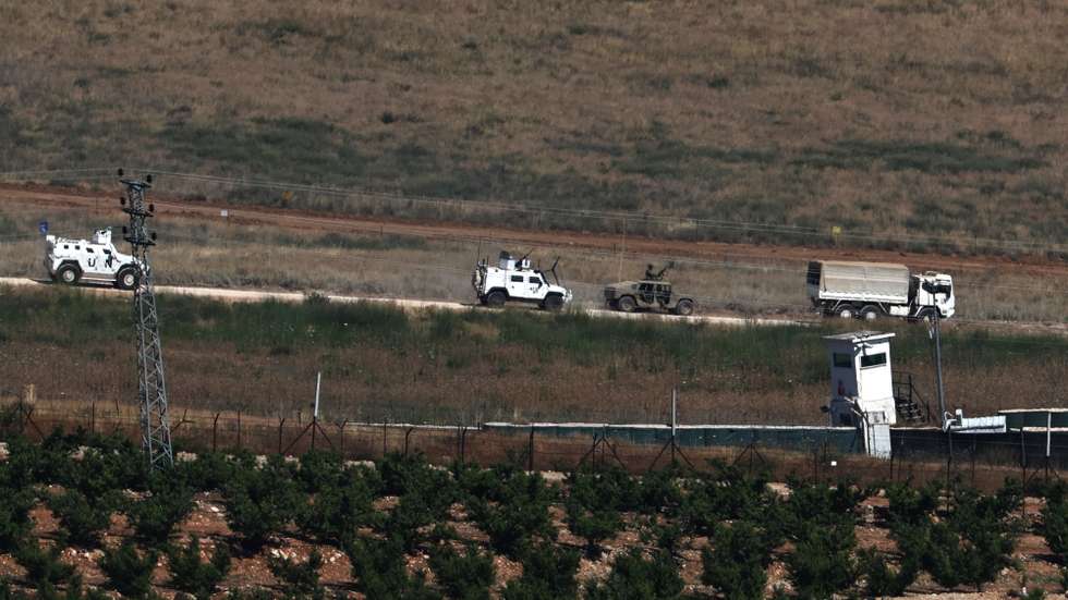 epa13011647 An Israeli military vehicle drives past a United Nations Interim Force in Lebanon (UNIFIL) convoy within southern Lebanon, as seen from the Israeli side of the border in the Upper Galilee, northern Israel, 02 June 2026, amid a ceasefire between Israel and Hezbollah.  EPA/ATEF SAFADI