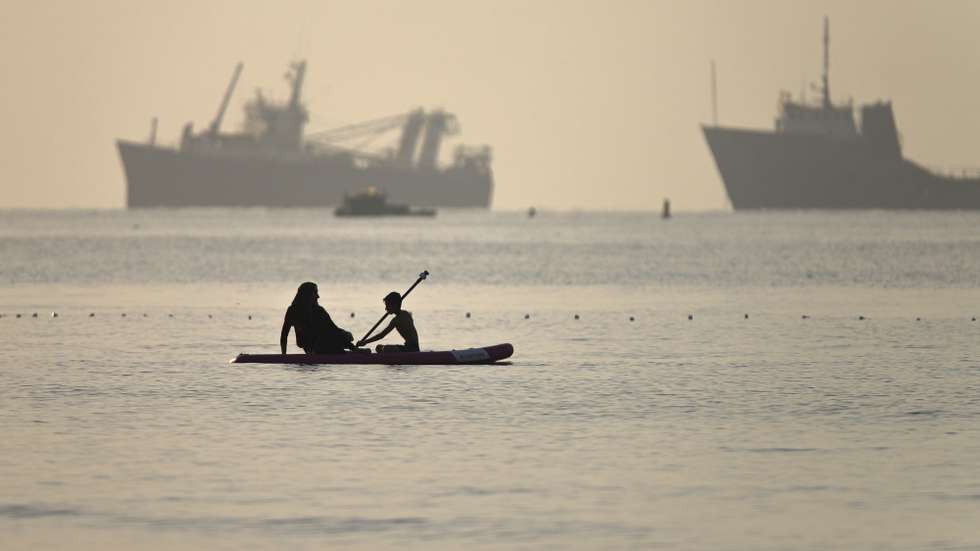 epa13009257 A handout photo made available by Isna News Agency shows an Iranian woman and her son paddleboarding past ships stuck in the Strait of Hormuz, along the coast of Bandar Abbas, in southern Iran, 01 June 2026. According to Iranian state media, the military's central command warned all vessels to secure Islamic Revolution Guards Corps (IRGC) Navy clearance to pass through the strait or face maritime security risks.  EPA/AMIRHOSSEIN KHORGOOEI/ ISNA NEWS AGENCY HANDOUT RESTRICTIONS: NO Access Israel Media/Persian Language TV Stations Outside Iran/Strictly No Access BBC Persian/VOA Persian/Manoto TV/Iran International TV. (As mandated by Iran's Directorate General for Foreign Media) -- HANDOUT EDITORIAL USE ONLY/NO SALES