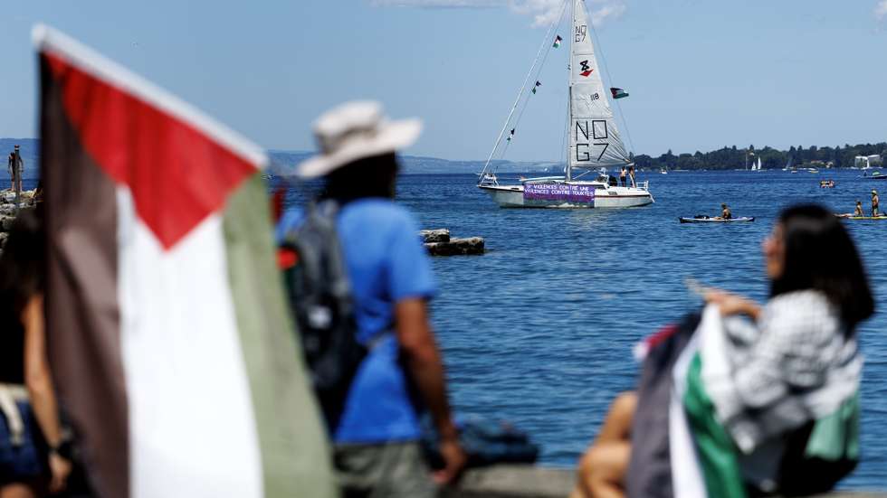 epa13036200 A banner on a sailboat of the Global Sumud Flotilla, decorated with Palestinian flags, reads 'Violence against one, violence against all, solidarity with Palestine' ahead of a demonstration against the G7 summit in Geneva, Switzerland, 14 June 2026. Protests opposing the G7 summit, which is scheduled to take place from 15 to 17 June 2026 in Evian, France, are centered this weekend in nearby Geneva. Activists have chosen Geneva for its accessibility compared to the high-security perimeter surrounding Evian.  EPA/CYRIL ZINGARO