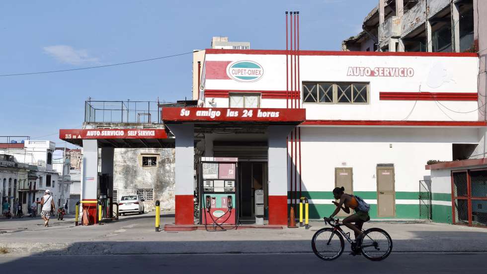 epa13083801 A person rides a bicycle past an empty gas station in Havana, Cuba, 02 July 2026 (issued 03 July 2026). Six months of a US 'maximum pressure' campaign have left Cuba facing a surge in power outages. The policy uses a strict oil embargo, economic sanctions, and implicit threats of military intervention to isolate the island nation.  EPA/Ernesto Mastrascusa