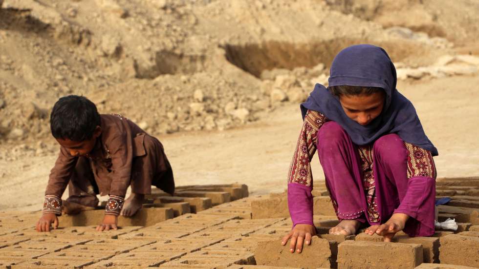 epa13061775 Afghan children work at a brick kiln in Kandahar, Afghanistan, 24 June 2026. The International Labour Organization has described a system in Afghan brick kilns in which advances on future wages can trap families in bonded labor, while UNICEF reported that 1 in 5 children aged 5-17 in Afghanistan is engaged in child labor.  EPA/QUDRATULLAH RAZWAN