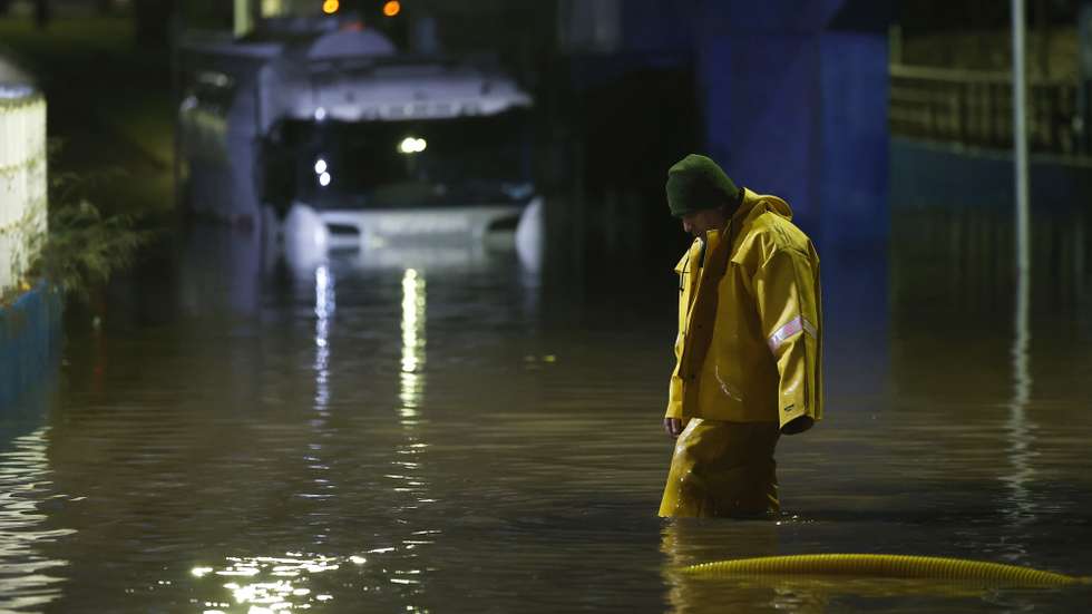 epa13118289 A man attempts to move a truck stuck on a flooded street following heavy rains in the San Bernardo district of Santiago, Chile, 17 July 2026.  EPA/ELVIS GONZALEZ