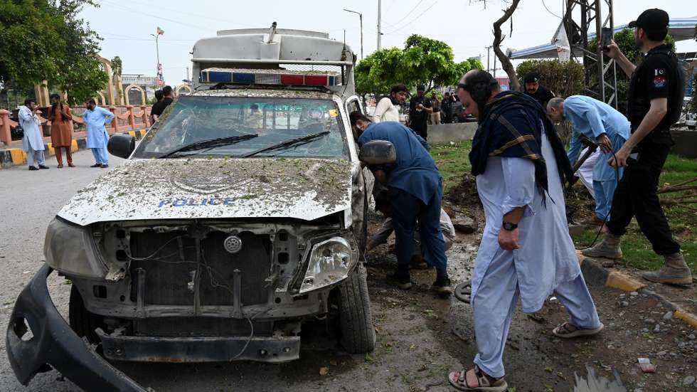 epa13146980 Security officials inspect the site of a roadside IED blast that targeted a police vehicle in Peshawar, Pakistan, 02 August 2026. Two police personnel suffered minor injuries when an improvised explosive device (IED) exploded near a police van close to the Peshawar-Islamabad motorway toll plaza near Pir Zakorhi Bridge. The attack came amid a recent surge in militant violence across Khyber Pakhtunkhwa targeting security forces.  EPA/BILAWAL ARBAB