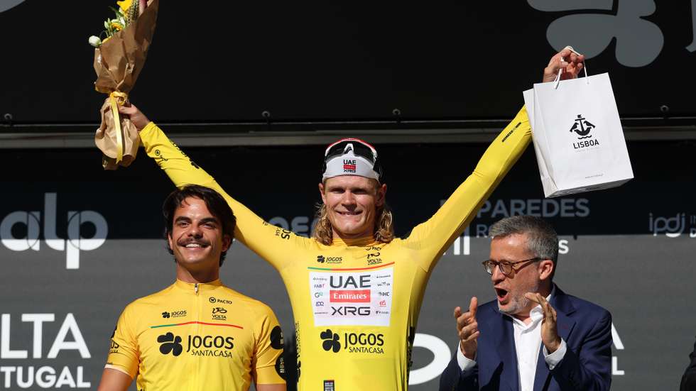 Danish rider Julius Johansen (UAE team Emirates - XRG) celebrates in the podium with the Lisbon Mayor Carlos Moedas (R) after winning the prologue of the 87th Portugal Cycling Tour a 6Km Individual Time Trial in Lisboa, Portugal, 05 August 2026. NUNO VEIGA/LUSA