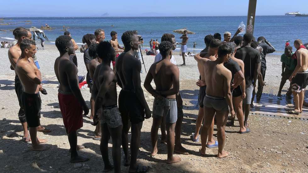 epa13151265 Young migrants shower at Trampolin Beach in Ceuta, Spain, 05 August 2026, after entering the Spanish enclave on 30 July during a mass crossing at the border breakwater.  EPA/Reduan