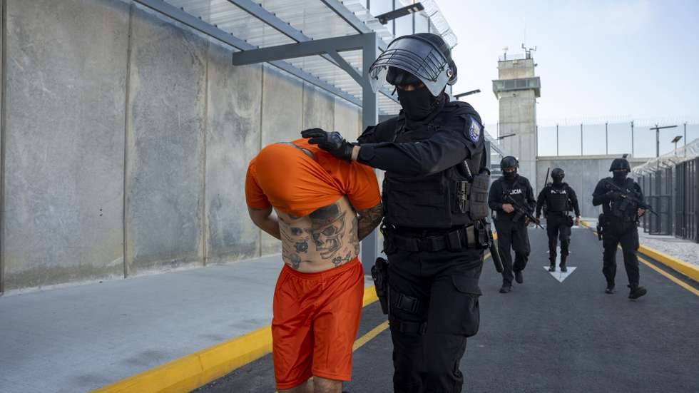 epaselect epa12837105 A police officer escorts Angel Esteban Aguilar Morales, alias Lobo Menor, at the Encuentro prison in Santa Elena, Ecuador, 20 March 2026. Aguilar, one of the leaders of Los Lobos, Ecuador’s most powerful criminal gang, was incarcerated at the maximum-security Encuentro Prison after being arrested in Mexico for his alleged involvement in the 2023 murder of Ecuadorian presidential candidate Fernando Villavicencio.  EPA/STR