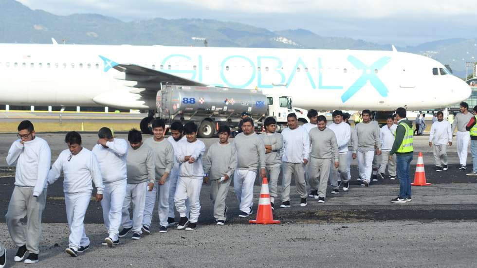 epa12618705 People walk at the Guatemalan Air Force base after arriving on the last deportation flight of the year from the United States, in Guatemala City, Guatemala, 30 December 2025.  EPA/ALEX CRUZ