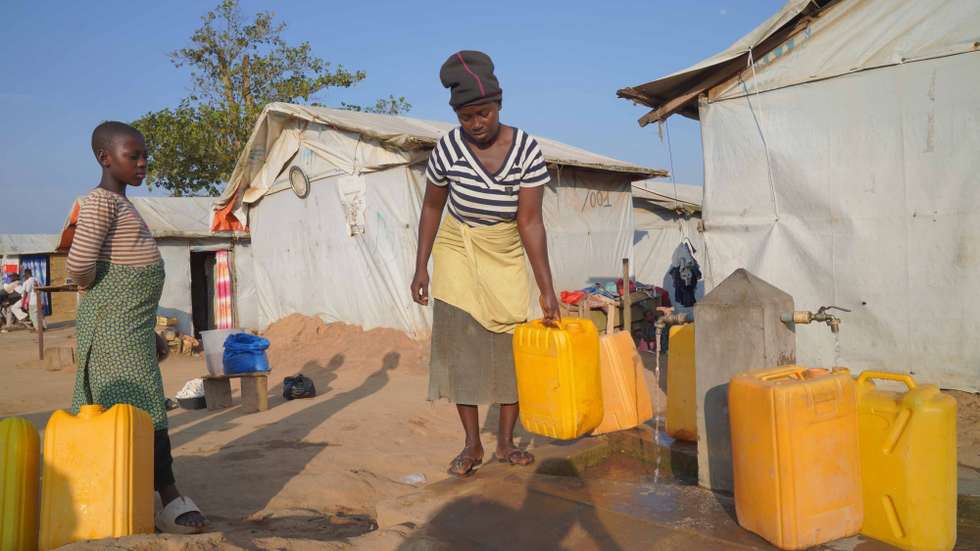 epa13189620 A woman fills water containers in a camp in Mambasa, Ituri, Democratic Republic of Congo, 24 August 2026. The Ebola outbreak has reached Mambasa, where the local branch of the Nouvelle Societe Civile du Congo (SOCICO) says delays in laboratory results have fueled community resistance to response measures amid persistent insecurity.  EPA/DIEUDONNE DIROLE