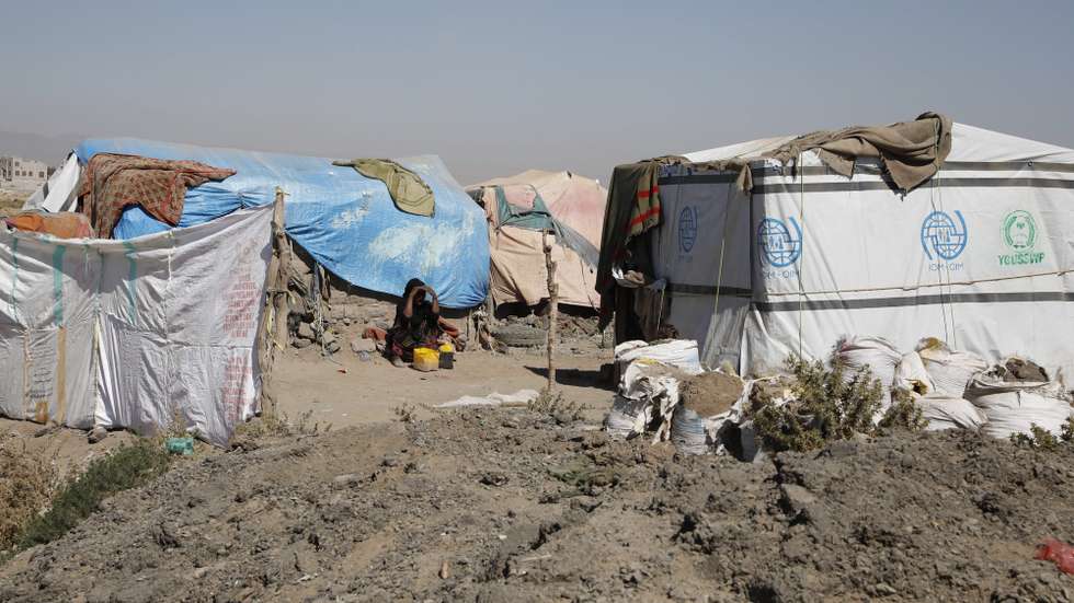 epa10353995 A displaced Yemeni woman sits by makeshift shelters at a camp for Internally Displaced Persons (IDPs) on the outskirts of Sana'a, Yemen, 05 December 2022 (issued 07 December 2022). More than 4.3 million people are estimated to have been internally displaced in war-ravaged Yemen, including 53,376 people who are newly displaced in 2022, according to the United Nations High Commissioner for Refugees (UNHCR). Most of them are in need of humanitarian aid for their day-to-day needs to survive. About 40 percent of the displaced are living in unofficial displacement camps and do not have adequate access to basic services. Yemen is in its eighth year of war since the Houthis took over the capital Sana'a and the northern parts of the Arab country and then the Saudi-led military coalition intervened in Yemen's conflict to restore the government.  EPA/YAHYA ARHAB