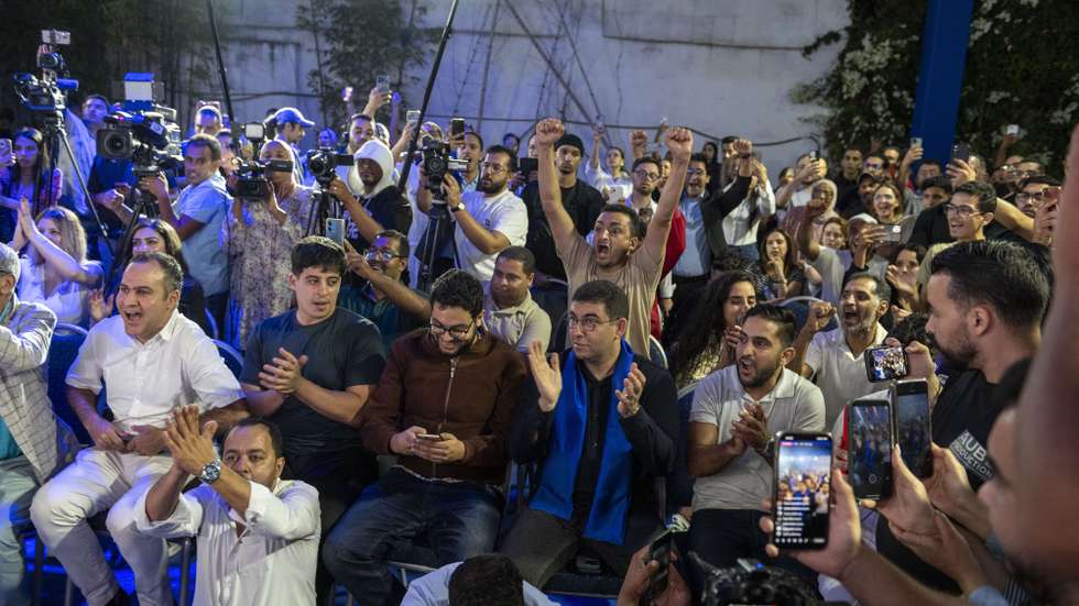 epa13259042 Mehdi Bensaid (C-R, blue scarf), a member of the collective leadership of the Authenticity and Modernity Party (PAM), waits for the Interior Minister's announcement of the preliminary results of the 2026 legislative elections, in Rabat, Morocco, 24 September 2026. The PAM won 97 seats, followed by the National Rally of Independents (RNI) with 66 seats, the Istiqlal Party with 65 seats and the Justice and Development Party (PJD) with 54 seats, according to the preliminary results announced by the Interior Ministry.  EPA/JALAL MORCHIDI