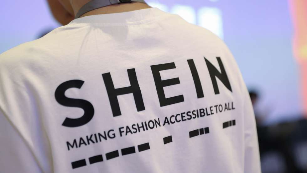 epa13203512 A person wearing a shirt with a SHEIN logo takes part in SHEIN’s listing ceremony at the Hong Kong Exchanges and Clearing Limited (HKEX) in Hong Kong, China, 01 September 2026.  EPA/MAY JAMES