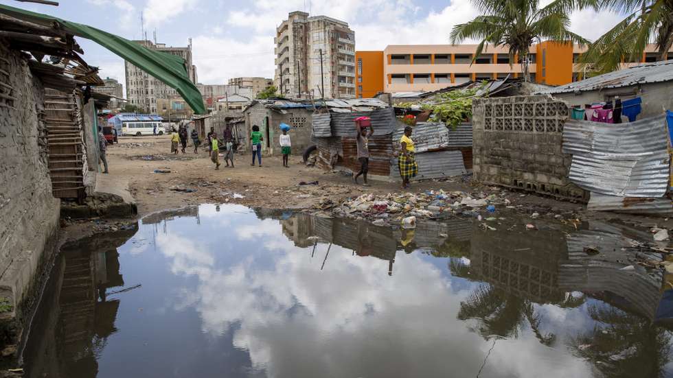 epa08251373 A handout photo made available by the United Nations Capital Development Fund (UNCDF) shows people make their way across streams as some roads have flooded after recent rains in the Praia Nova neighbourhood in Beira, Mozambique, 26 February 2020 (issued 27 February 2020). Most parts of the neighbourhood were completely flooded during cyclone Idai in 2019. The climate crisis is having serious consequences in Mozambique, with parts of the country experiencing drought while others have endured floods and disease outbreaks. The recurrence of these climatic shocks in shorter cycles challenges efforts to reduce vulnerability and decimates familiesâ€™ livelihoods. One year after cyclone Idai made landfall in Mozambique, there are still 2.5 million people in urgent need of assistance.  EPA/KAREL PRINSLOO / HANDOUT  HANDOUT EDITORIAL USE ONLY/NO SALES