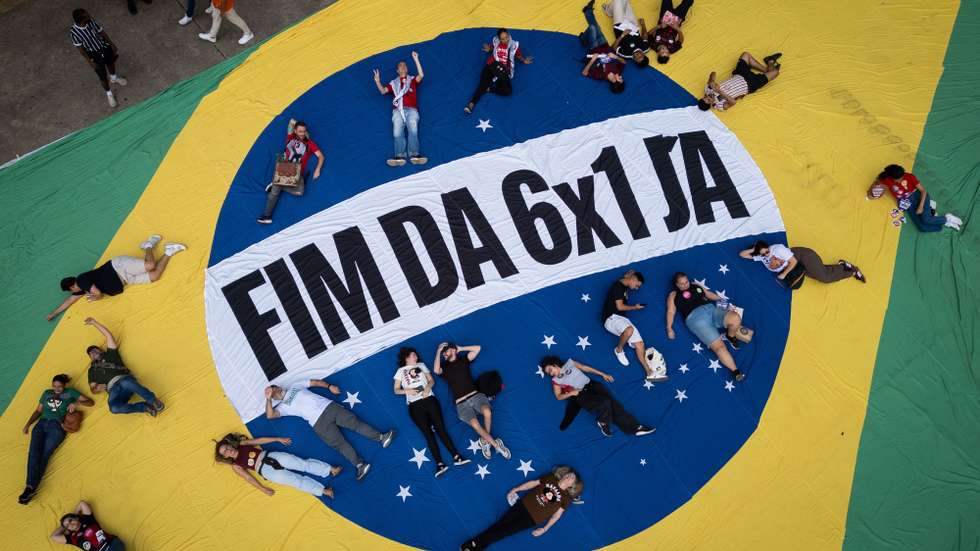 epa12927012 Aerial photograph showing people posing on a Brazilian flag during a demonstration in the commemoration of International Workers' Day in Sao Paulo, Brazil 01 May 2026.  EPA/Isaac Fontana