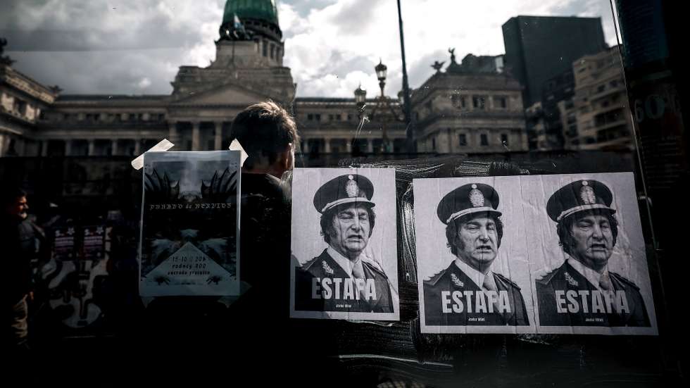 epa13307966 Posters depicting Argentine President Javier Milei with the word 'Scam' are displayed during a protest against his government in Buenos Aires, Argentina, 15 October 2026. Opposition lawmakers failed to secure the quorum needed for the Chamber of Deputies to debate rejecting Milei's emergency decree DNU 70/2023, which introduced sweeping economic deregulation measures.  EPA/JUAN IGNACIO RONCORONI