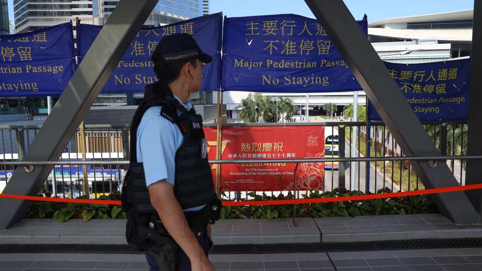 epa13274334 A Hong Kong police officer walks along a bridge in Hong Kong, China, 01 October, 2026. The city celebrates China's National Day on 01 October 2026, marking the 77th founding anniversary of the People's Republic of China.  EPA/MAY JAMES