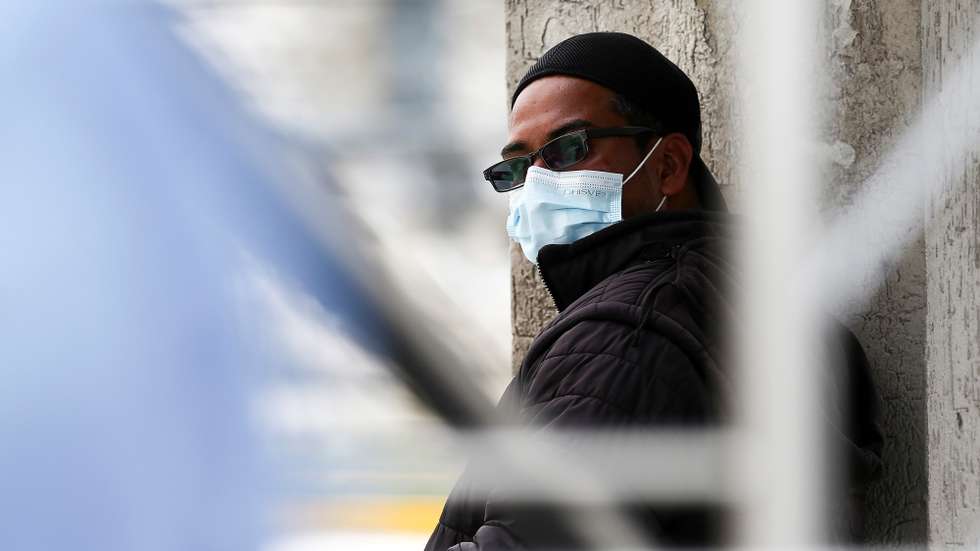 epa08947266 A man waits outside the IESS del Sur Hospital, which houses a large number of patients with symptoms related to COVID-19, in Quito, Ecuador, 18 January 2021. Ecuador has experienced growing hospital pressure in recent weeks, and also an increase in deaths, which however does not seem to reflect a second wave of infections, and which could still be due to the 'Christmas' effect.  EPA/Jose Jacome