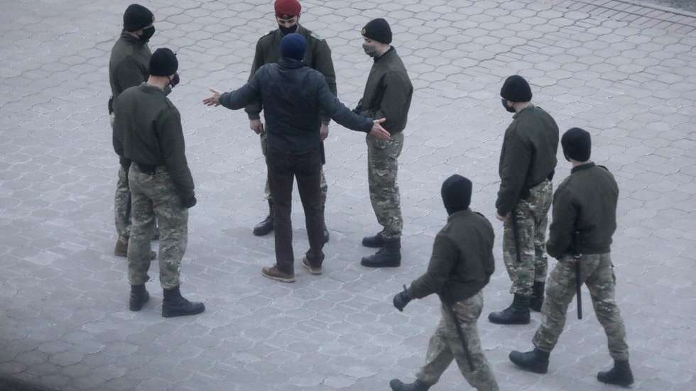 epa09097529 Belarusian policemen surround a man during the Freedom Day in Minsk, Belarus, 25 March 2021. Freedom Day, an unofficial holiday in Belarus, commemorates the creation of the Belarusian People's Republic (BPR) on 25 March 1918. People celebrated Freedom Day to show support to imprisoned protesters and to protest against the government of Belarusian President Lukashenko.  EPA/STR