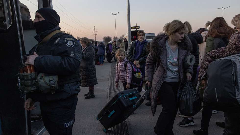epa09850008 People who fled from the besieged by Russian military southeastern city of Mariupol and occupied Melitopol gather after arriving at the evacuation point in Zaporizhzhia, Ukraine, 25 March 2022. Hundreds of people were evacuated on 25 March from the southeastern cities of Mariupol and Melitopol and arrived in Ukraine's controlled area by buses and their own cars. Almost 100,000 residents remain trapped and live in 'inhuman conditions' without food and water in the ruined city of Mariupol, amid Russia's 'constant shelling', Ukrainian president Volodymyr Zelenskyy says.  EPA/ROMAN PILIPEY