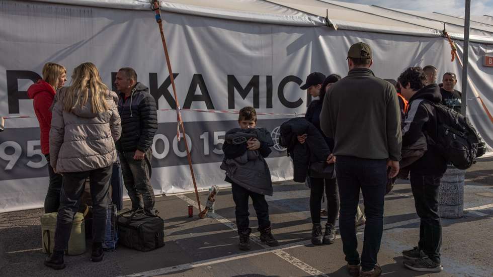 epa09924949 Evacuated family from Mariupol's steel plant Azovstal gather after arriving on a bus at the evacuation point in Zaporizhzhia, Ukraine, 03 May 2022. Around 100 civilians were evacuated from the steel plant, the last Ukrainian-controlled area in the southern port city of Mariupol, according to Ukrainian officials. Thousands of people who were still in Mariupol and other areas in South Ukraine occupied by the Russian army waited to be evacuated to Ukraine's controlled area by buses and their own cars.  EPA/ROMAN PILIPEY