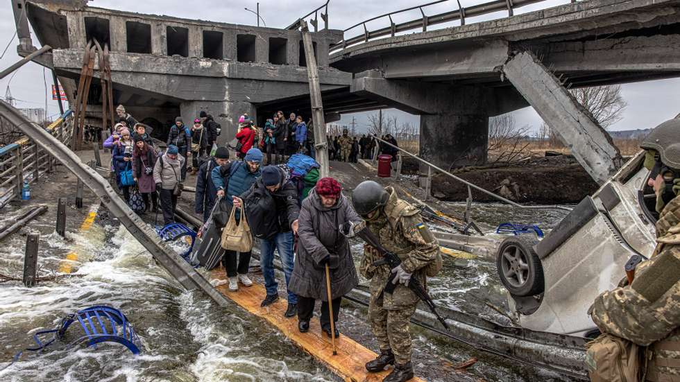 epa10134541 (FILE) - People cross the destroyed bridge as they flee from the frontline town of Irpin, Kyiv (Kiev) region, Ukraine, 07 March 2022. (Issued 23 August 2022). Ukraine marks, on 24 August 2022, six months since the war with Russia started.  EPA/ROMAN PILIPEY  ATTENTION: This Image is part of a PHOTO SET