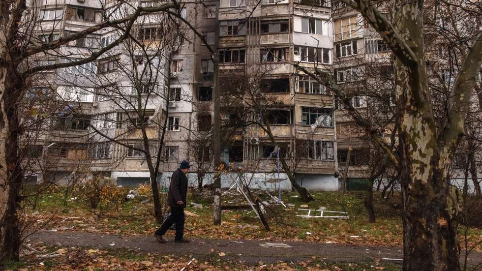 epa10327788 A man walks past at a damaged residential building after the recent Russian attack in Kherson, southern Ukraine, 25 November 2022. Russian troops for the past few days intensified the shelling of Kherson. On its retreat from Kherson, the Russian army destroyed critical infrastructure in the city, including electricity and water supplies. Now the lack of electricity and running water in the town during the winter season has forced many locals to flee Kherson.  EPA/ROMAN PILIPEY